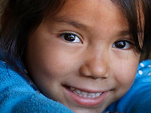 Girl in blue sweater smiling