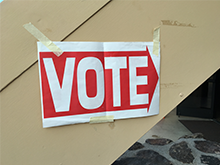 An Arrow posted on a wall that says Vote