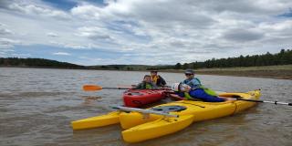 A family on the water in kayaks in Flagstaff Arizona